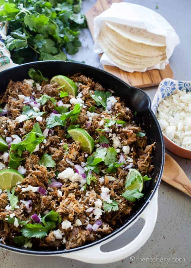 Slow Cooker Pork Carnitas Recipe | Make taco night a special night! Ditch the ground beef with the taco seasoning and try these easy and flavorful slow cooker authentic pork carnitas tacos. | The Noshery