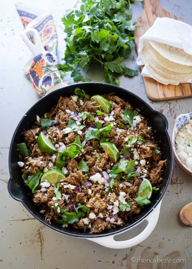 Slow Cooker Pork Carnitas Recipe | Make taco night a special night! Ditch the ground beef with the taco seasoning and try these easy and flavorful slow cooker authentic pork carnitas tacos. | The Noshery