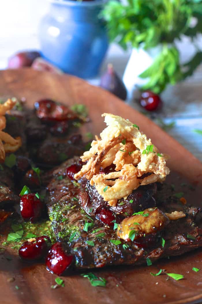 Grilled Skirt Steak with Roasted Cherries and Figs with Crispy Onions | The Noshery