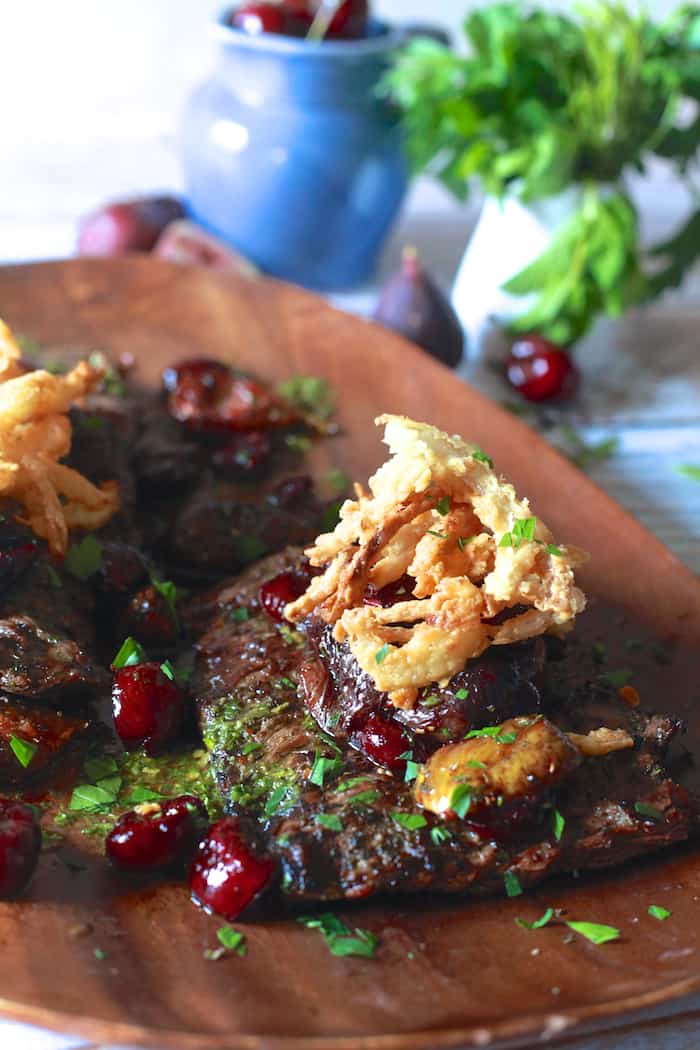 Grilled Skirt Steak with Roasted Cherries and Figs with Crispy Onions | The Noshery