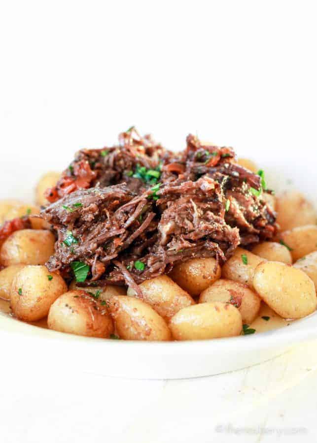 Braised Beef in Red Wine pilled over pan fried gnocchi potato dumplings. | The Noshery