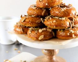 Pumpkin Spiced Donuts with Bourbon Caramel Glaze | A soft and nutty donut packed with pumpkin flavor. But wait, there’s more. I dipped them in a gooey bourbon caramel glaze! | TheNoshery.com