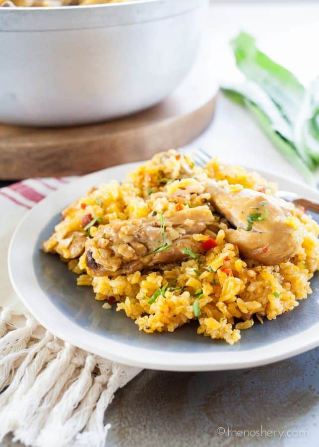 Arroz con Pollo - Chicken and yellow rice on a plate.