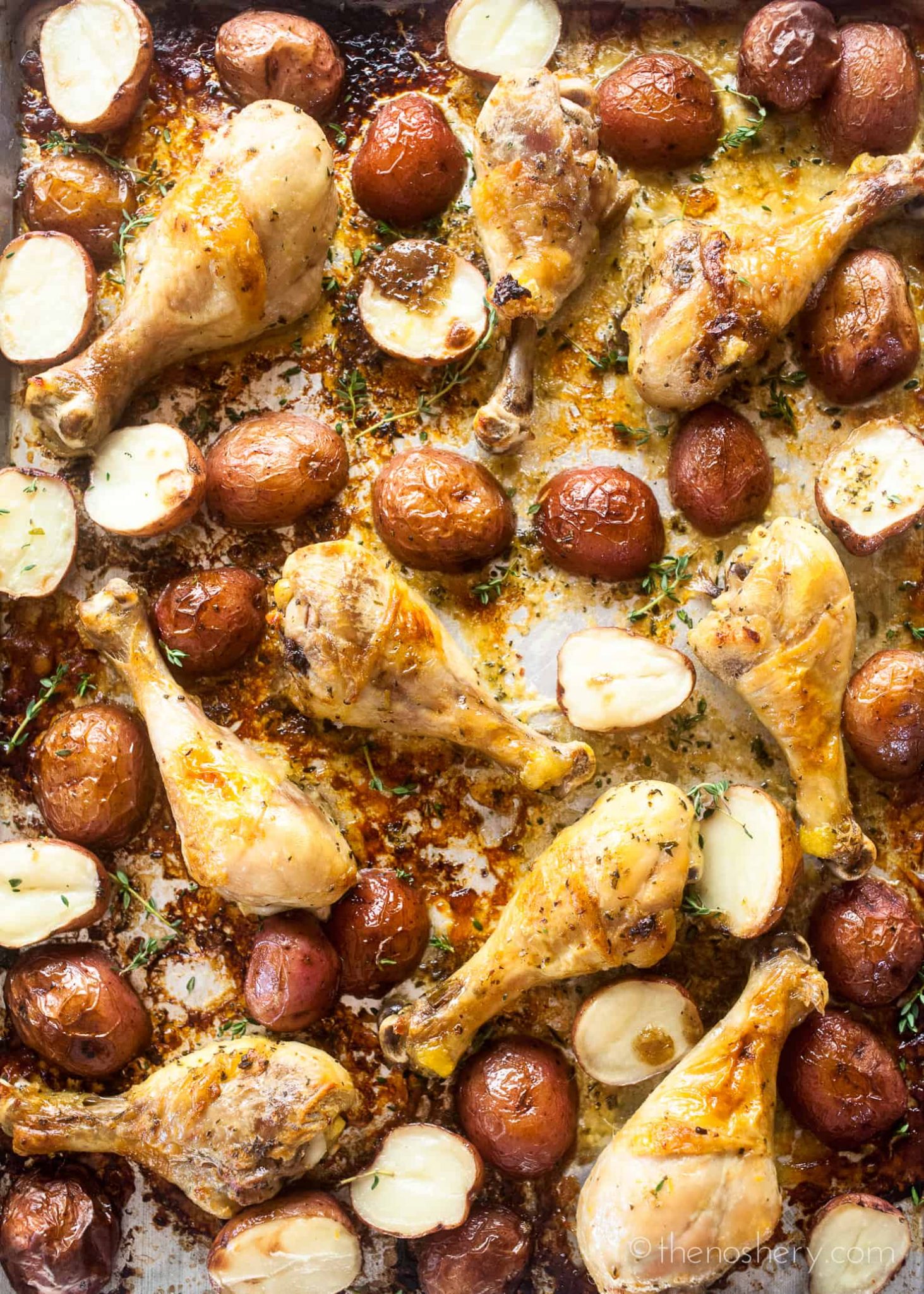 Baked Chicken Legs and Potatoes with Lemon and Herb - The Noshery