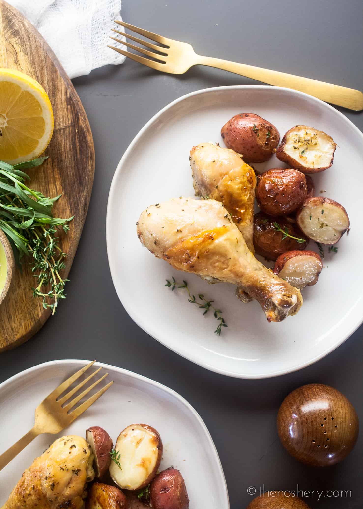 Baked Chicken Legs and Potatoes with Lemon and Herb - The Noshery