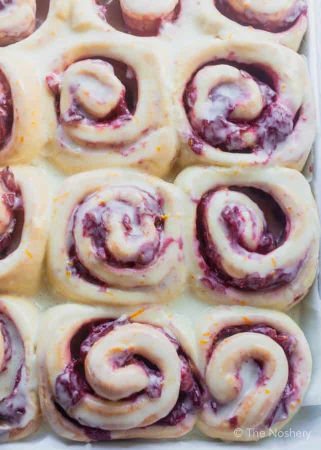 Cranberry Sweet Bread Rolls with Orange Icing | Sweet bread rolls filled with spiced tart cranberry sauce and topped with a sweet orange icing. A great treat for Christmas morning. | The Noshery