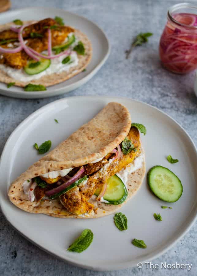 Chicken Shawarma Wraps | These chicken pitas are an adaptation of the popular middle eastern street food shawarma. The chicken tenderloins are rubbed with shawarma spices and served in a warm pita with tangy yogurt. This flavor bomb is a perfect weeknight meal | The Noshery