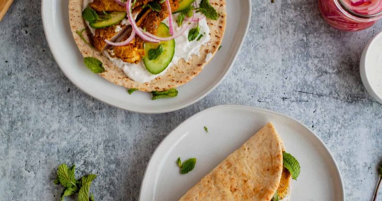 Chicken Shawarma Pitas | These chicken pitas are an adaptation of the popular middle eastern street food shawarma. The chicken tenderloins are rubbed with shawarma spices and served in a warm pita with tangy yogurt. This flavor bomb is a perfect weeknight meal | The Noshery
