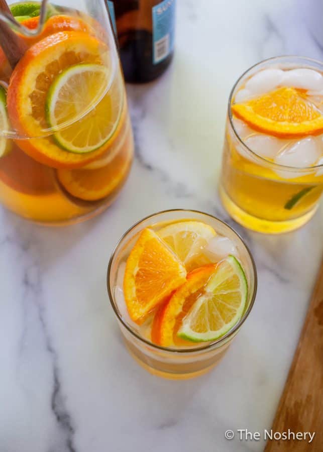 Summer Shandy Sangria | A combination of beer, lemonade, and fresh fruit is the marriage of two favorite summer drinks, shandy and sangria. | The Noshery