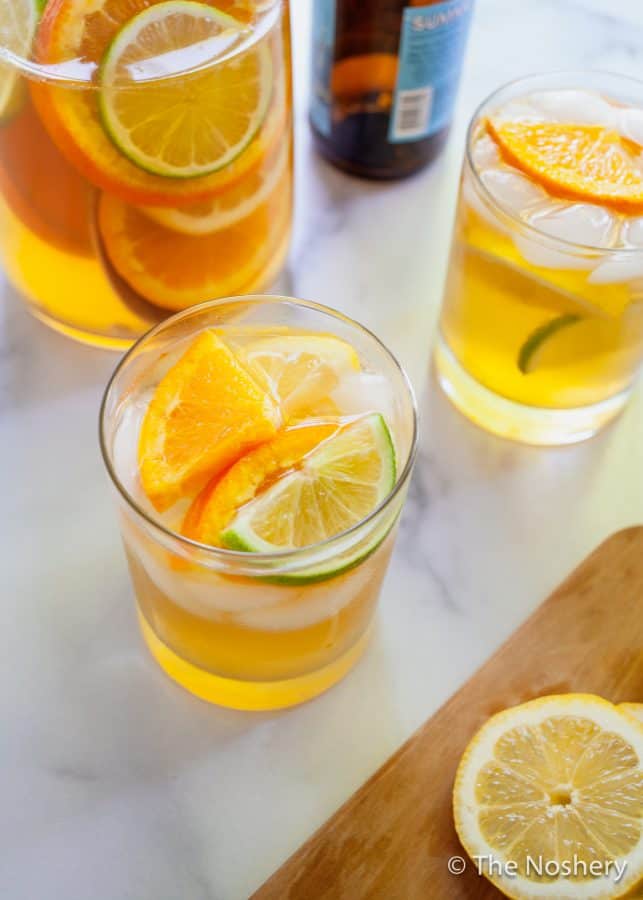 Summer Shandy Sangria | A combination of beer, lemonade, and fresh fruit is the marriage of two favorite summer drinks, shandy and sangria. | The Noshery