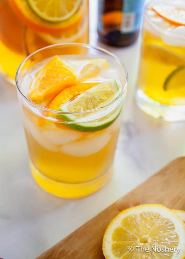 Summer Shandy Sangria | A combination of beer, lemonade, and fresh fruit is the marriage of two favorite summer drinks, shandy and sangria. | The Noshery