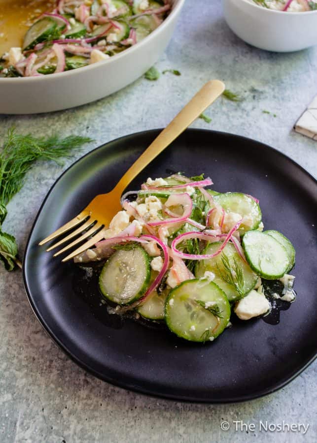 Cucumber Salad with Feta Cheese |This refreshing cucumber salad with feta cheese marinated in tangy vinegar and fresh herbs makes a tasty and refreshing side dish. Perfect for summer!| The Noshery