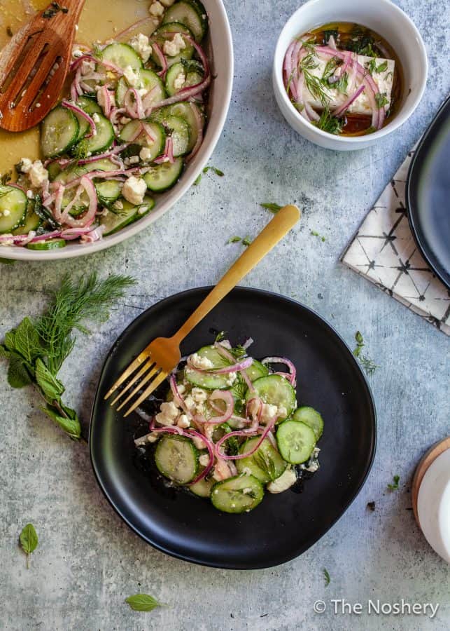 Cucumber Salad with Feta Cheese |This refreshing cucumber salad with feta cheese marinated in tangy vinegar and fresh herbs makes a tasty and refreshing side dish. Perfect for summer!| The Noshery