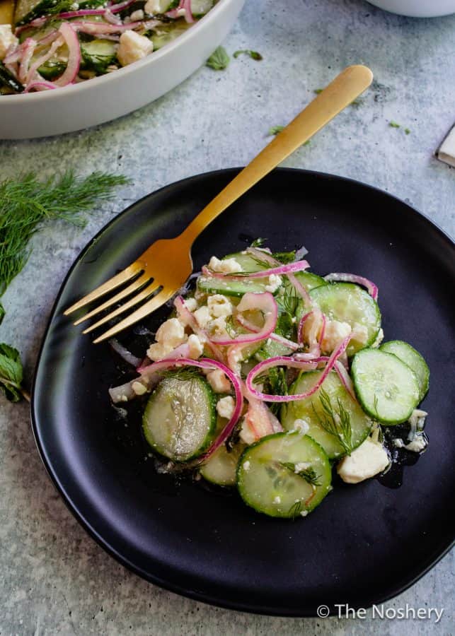Cucumber Salad with Feta Cheese |This refreshing cucumber salad with feta cheese marinated in tangy vinegar and fresh herbs makes a tasty and refreshing side dish. Perfect for summer!| The Noshery