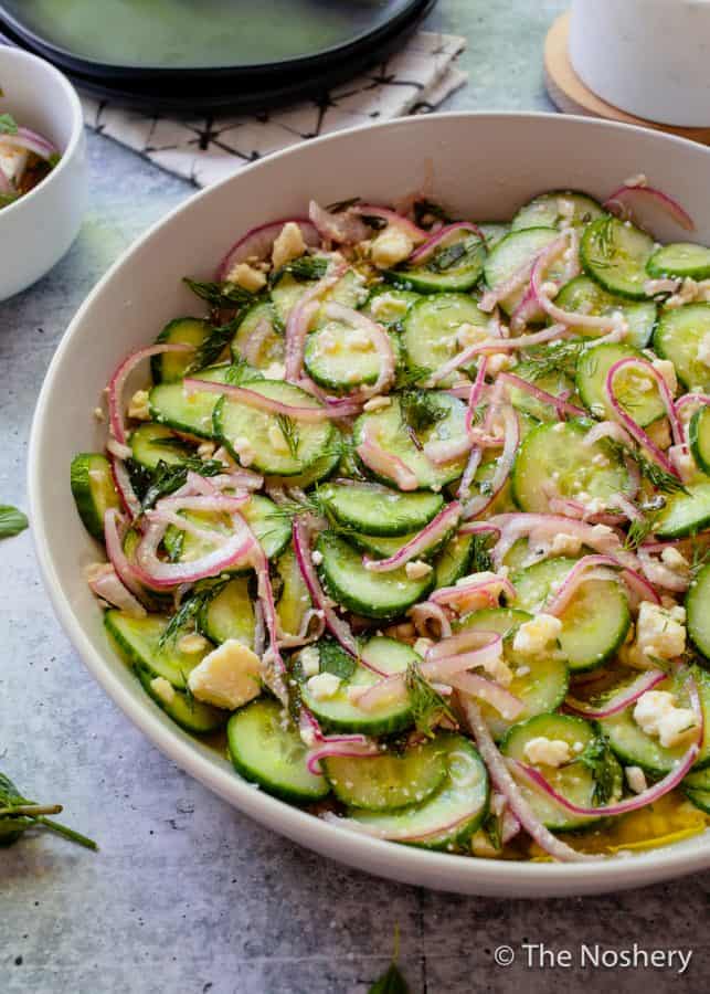 Cucumber Salad with Feta Cheese |This refreshing cucumber salad with feta cheese marinated in tangy vinegar and fresh herbs makes a tasty and refreshing side dish. Perfect for summer!| The Noshery